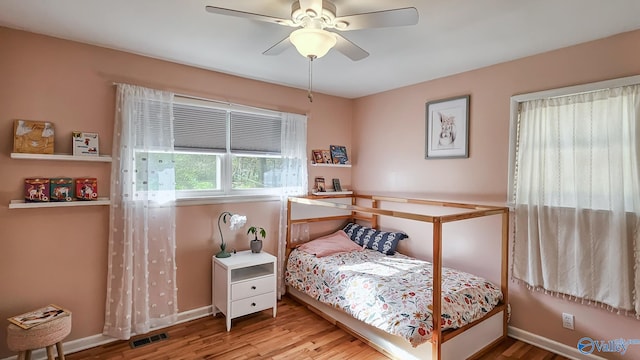 bedroom with ceiling fan and hardwood / wood-style floors