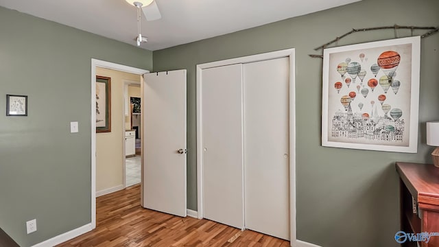 bedroom with a closet, ceiling fan, and hardwood / wood-style floors