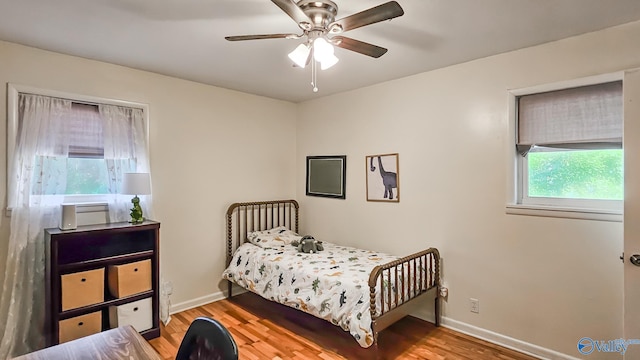 bedroom with ceiling fan and light hardwood / wood-style flooring