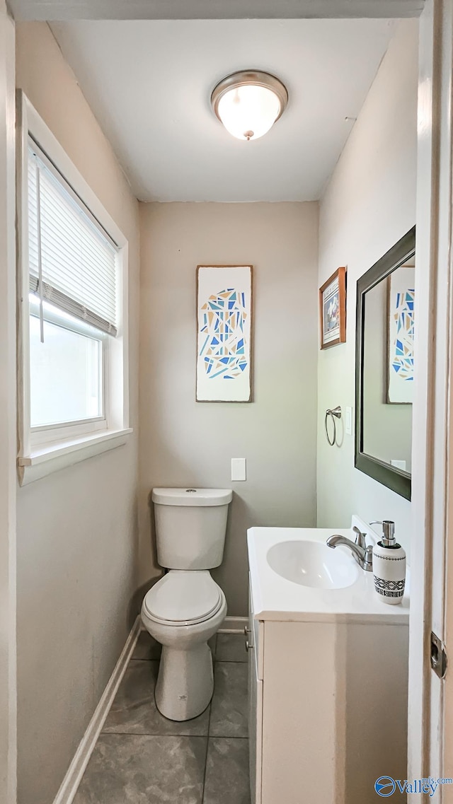 bathroom featuring tile patterned flooring, vanity, and toilet