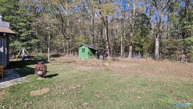 view of yard featuring a playground and a storage unit