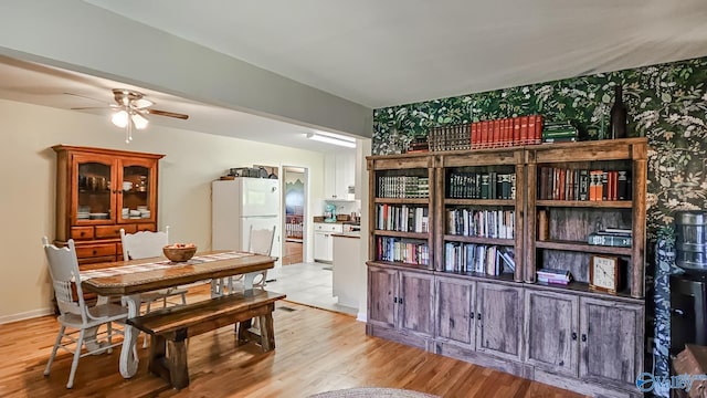 dining area featuring ceiling fan and light hardwood / wood-style floors