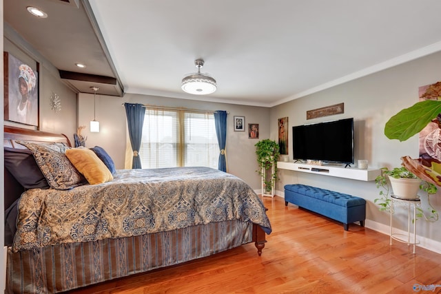 bedroom with light wood-type flooring and ornamental molding