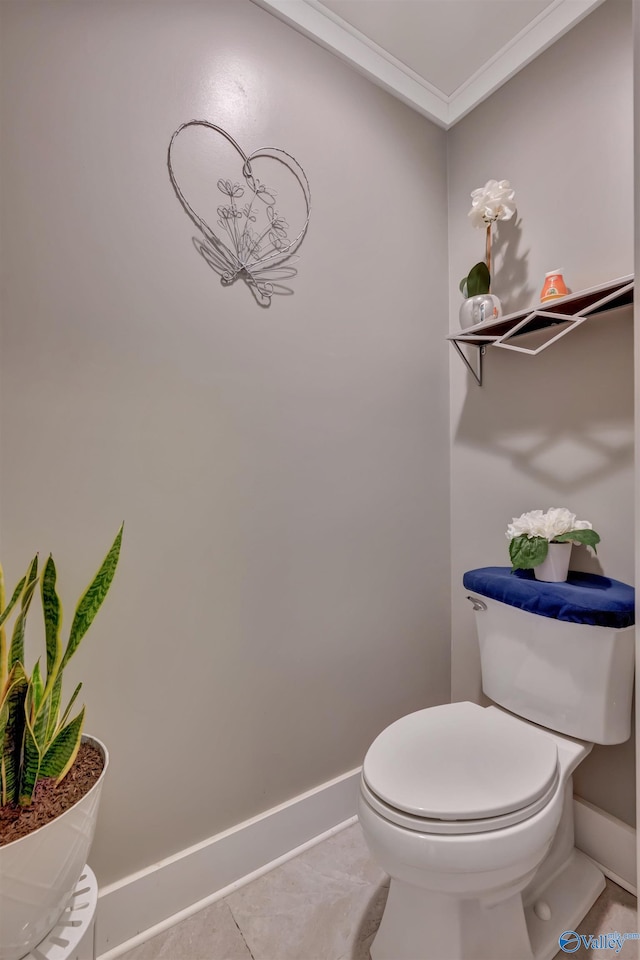 bathroom featuring toilet, ornamental molding, and tile patterned floors