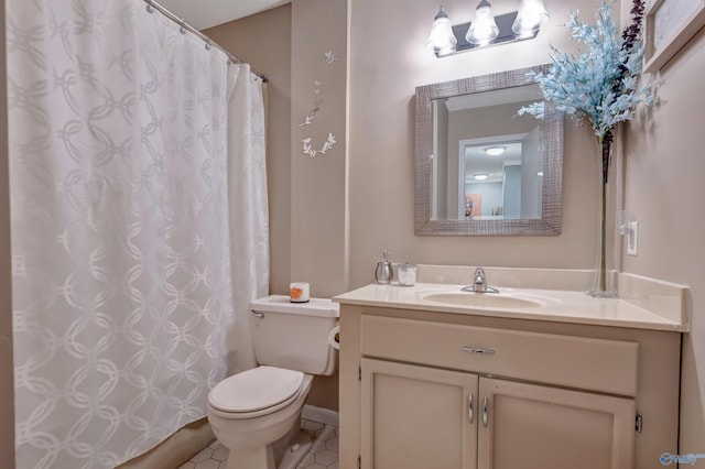 bathroom featuring toilet, vanity, and tile patterned flooring