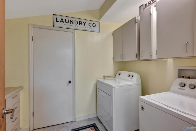 laundry area featuring washer and clothes dryer and cabinets