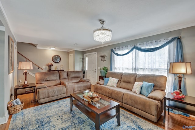 living room featuring wood-type flooring and ornamental molding