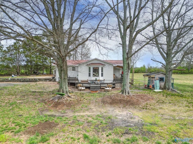 view of front of house with a wooden deck and an outbuilding