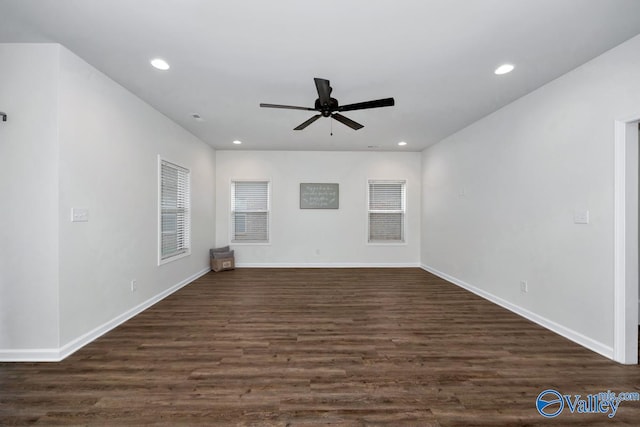 spare room with ceiling fan and dark hardwood / wood-style floors