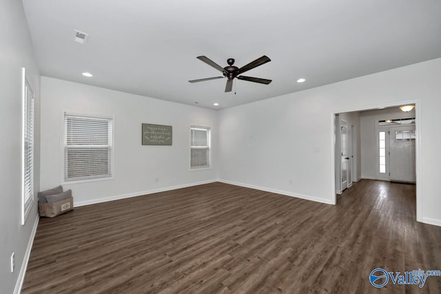 spare room with ceiling fan and dark hardwood / wood-style flooring