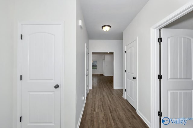 hallway with dark hardwood / wood-style floors