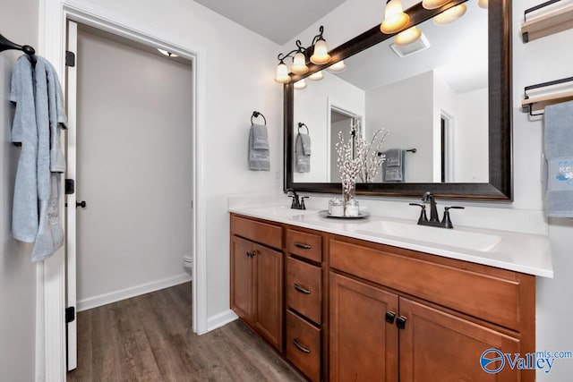 bathroom featuring toilet, vanity, and hardwood / wood-style flooring