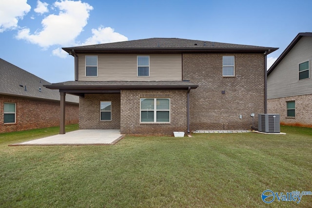 rear view of property featuring a yard, a patio, and central AC unit