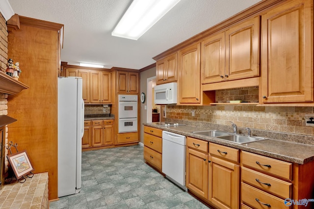 kitchen featuring light tile patterned flooring, crown molding, white appliances, sink, and backsplash