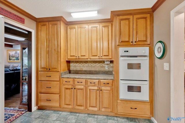kitchen with light tile patterned flooring, a textured ceiling, decorative backsplash, and double oven