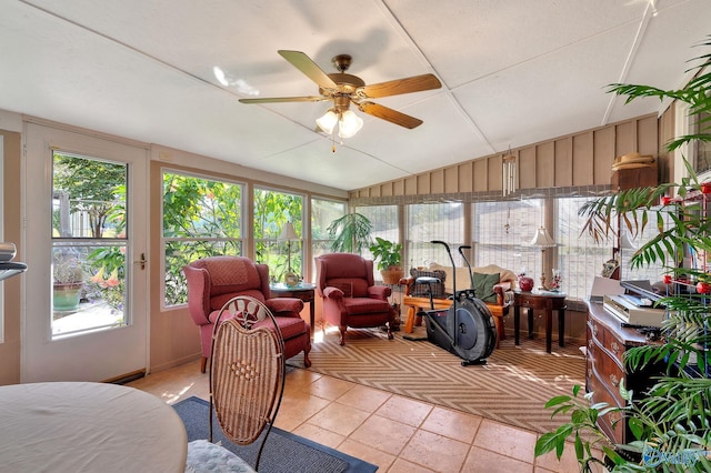 sunroom with ceiling fan and vaulted ceiling