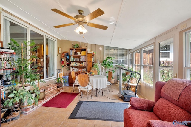 sunroom / solarium featuring ceiling fan