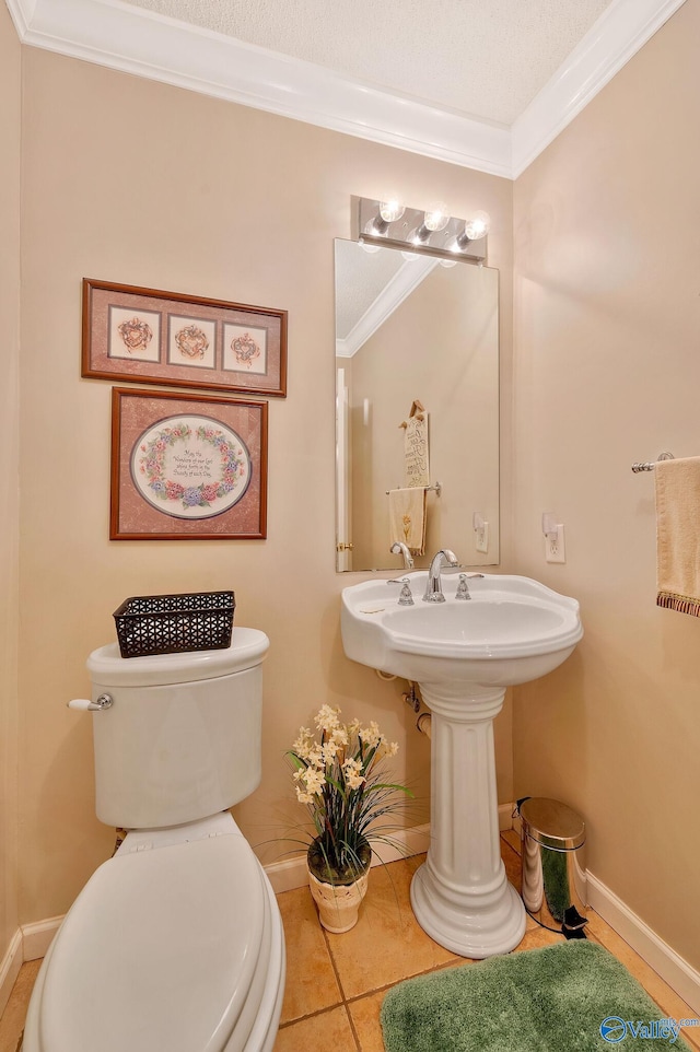 bathroom featuring tile patterned floors, crown molding, and toilet