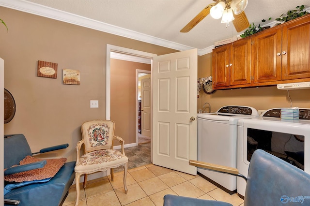 laundry area featuring light tile patterned flooring, ceiling fan, washer and clothes dryer, ornamental molding, and cabinets