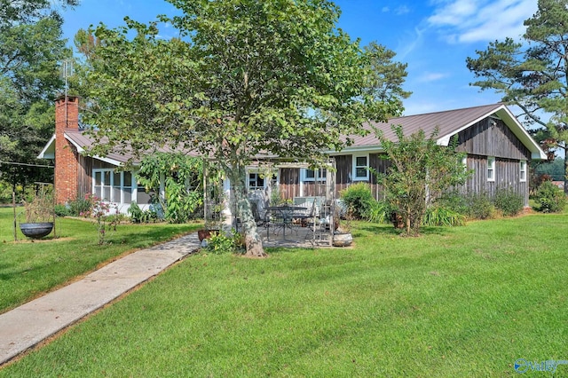 obstructed view of property featuring a patio area and a front yard