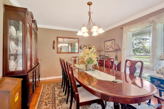 dining area with a notable chandelier, dark hardwood / wood-style flooring, and ornamental molding
