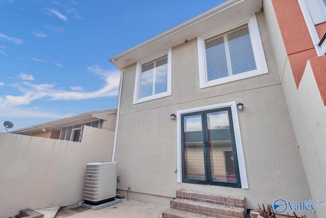 rear view of property with central AC unit