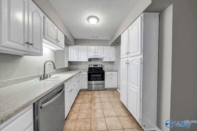 kitchen featuring white cabinetry, sink, a textured ceiling, and appliances with stainless steel finishes