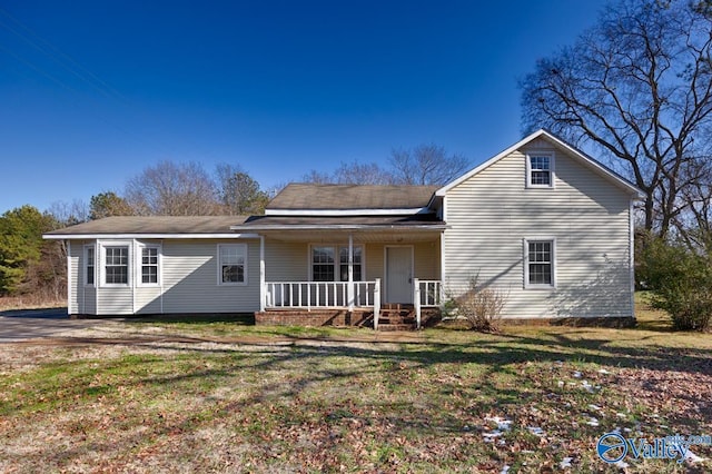 view of front of house with a front yard and a porch