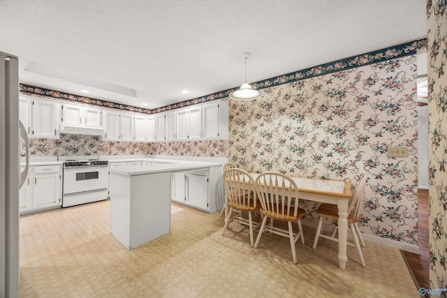 kitchen with white cabinets, a textured ceiling, decorative light fixtures, electric range, and a center island