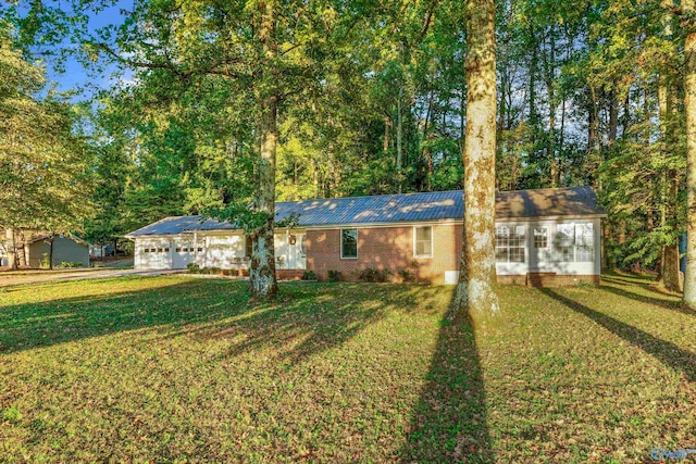 single story home featuring a front lawn and a sunroom