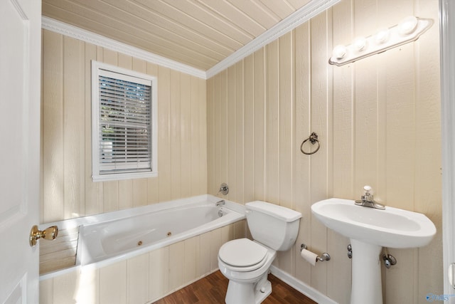 bathroom with ornamental molding, a bathtub, hardwood / wood-style floors, and toilet