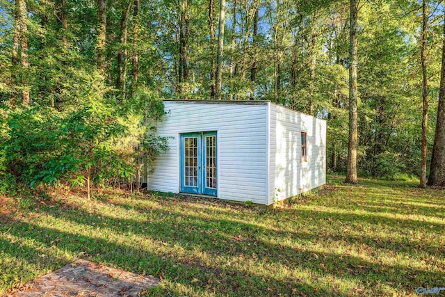 view of outbuilding featuring a lawn