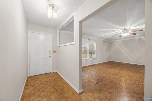 entrance foyer featuring ceiling fan, a textured ceiling, and parquet floors