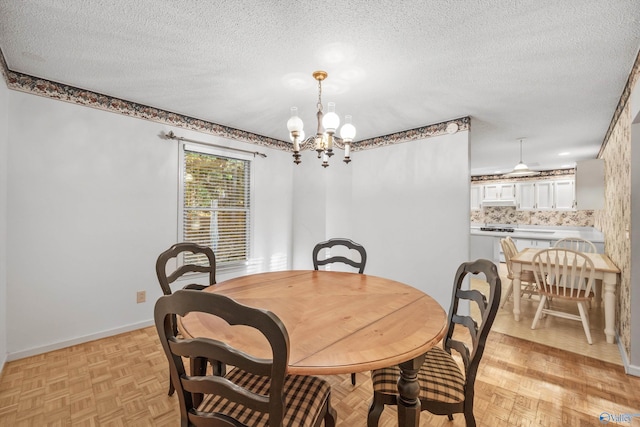 dining room featuring light parquet flooring, a chandelier, and a textured ceiling