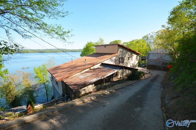 exterior space with metal roof and a water view