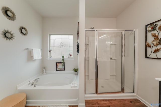 bathroom featuring plus walk in shower and hardwood / wood-style flooring