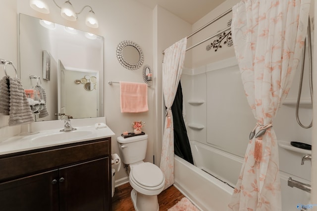 full bathroom featuring wood-type flooring, shower / bathtub combination with curtain, vanity, and toilet