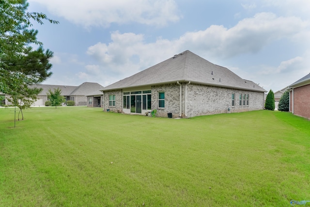 rear view of house with a yard