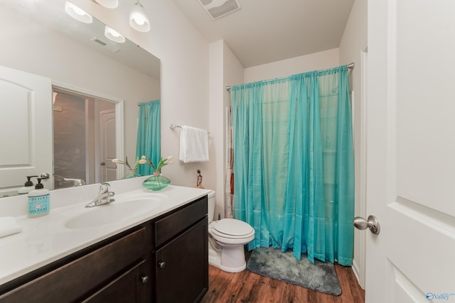 bathroom featuring hardwood / wood-style floors, vanity, and toilet