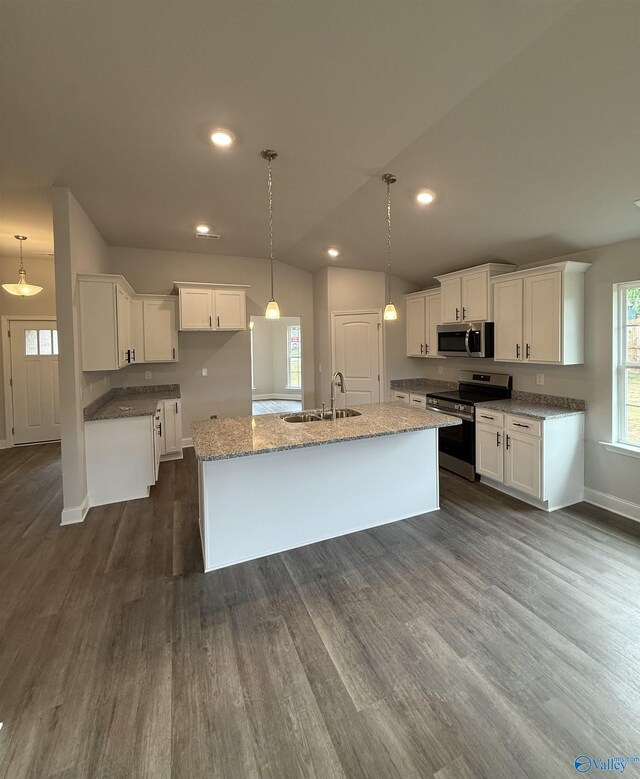 301 Carnation Ave, Meridianville, AL 35759 - kitchen featuring a center island with sink, a sink, white cabinets, stainless steel appliances, and dark wood-type flooring