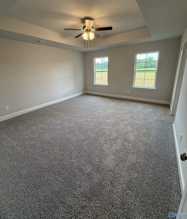 301 Carnation Ave, Meridianville, AL 35759 - carpeted spare room featuring baseboards, a ceiling fan, a tray ceiling, and visible vents