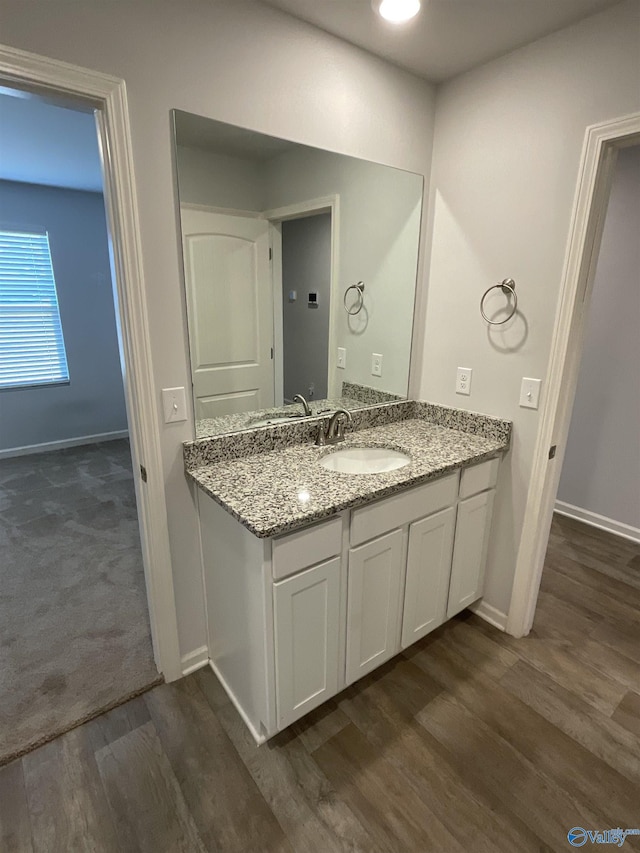 bathroom with vanity and hardwood / wood-style floors