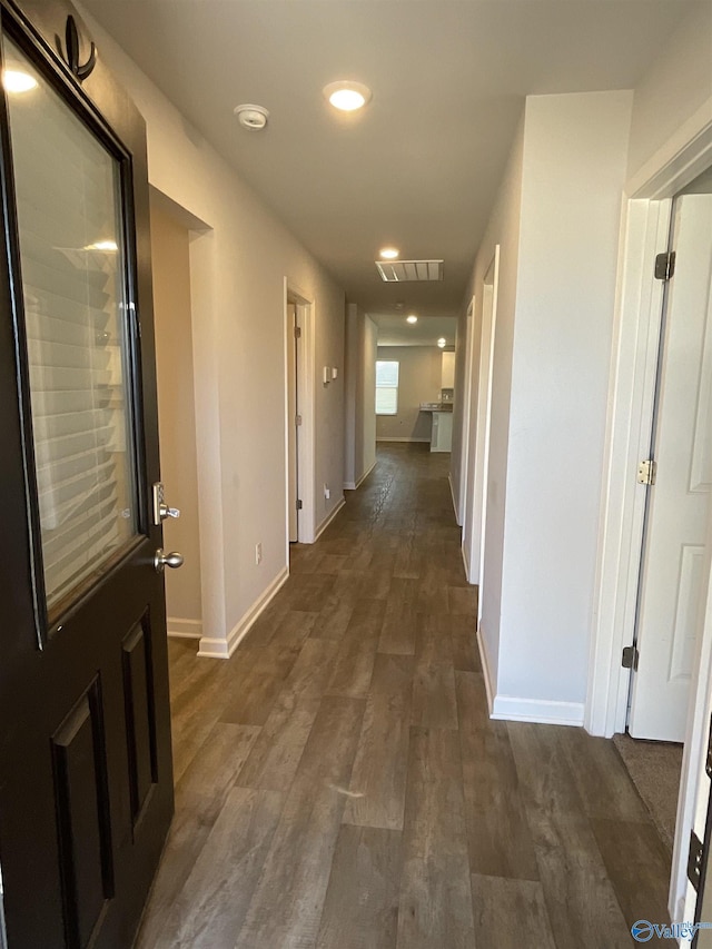 corridor featuring dark hardwood / wood-style flooring