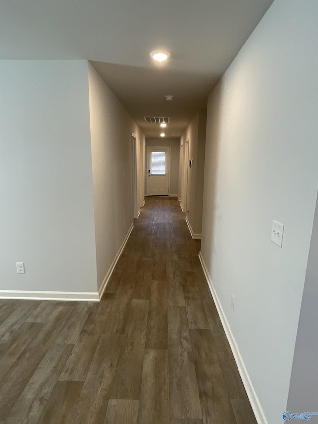 hallway with dark hardwood / wood-style flooring