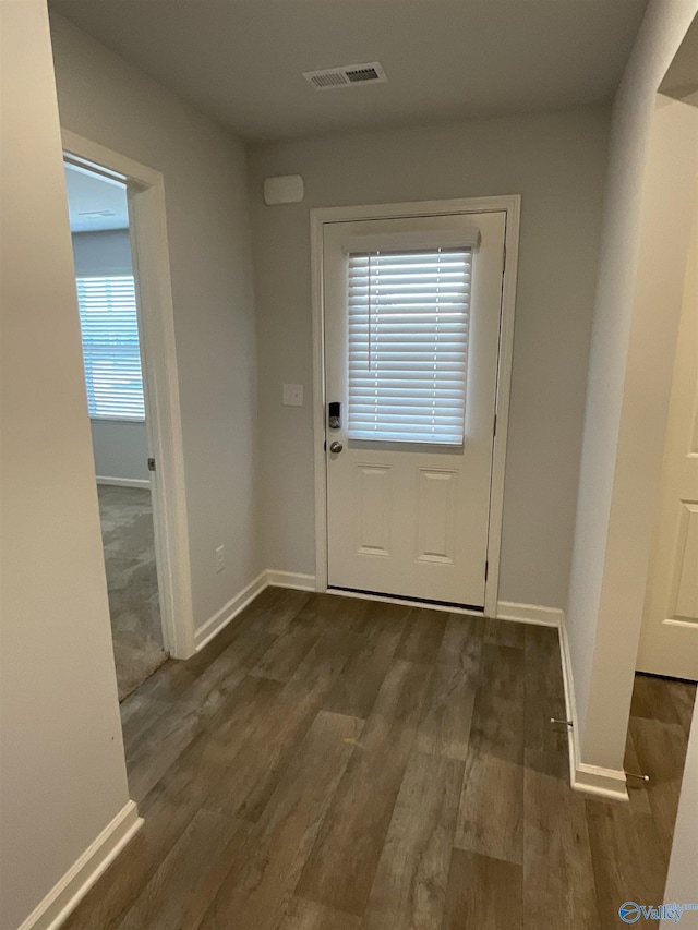 doorway with dark hardwood / wood-style flooring