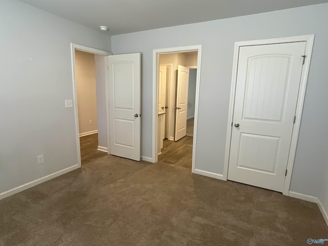 unfurnished bedroom with dark carpet