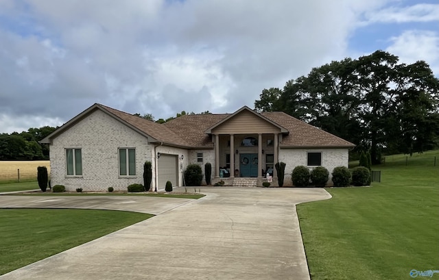 407 Barbee Ln, Scottsboro, AL 35769 - view of front of property with driveway, a front lawn, brick siding, a garage, and roof with shingles
