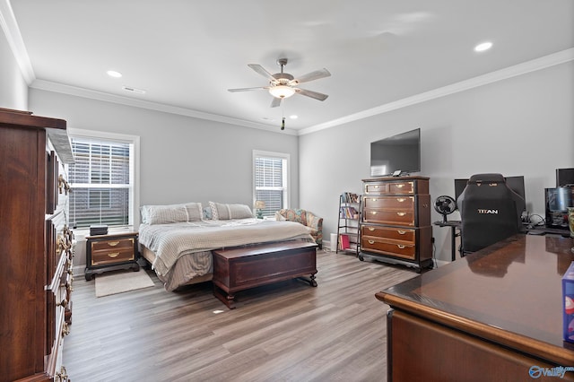 bedroom with light hardwood / wood-style flooring, ceiling fan, and crown molding