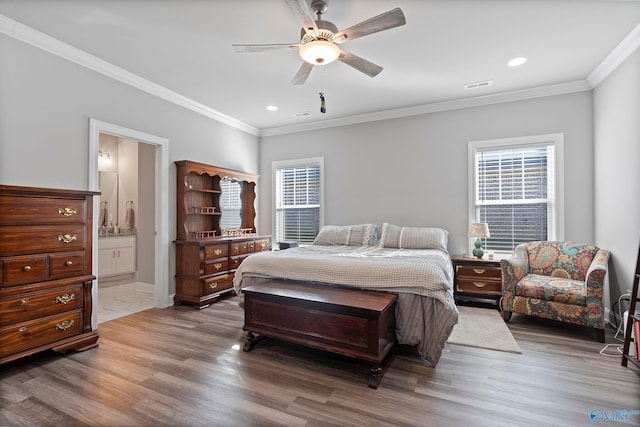 bedroom featuring connected bathroom, ceiling fan, ornamental molding, and hardwood / wood-style flooring