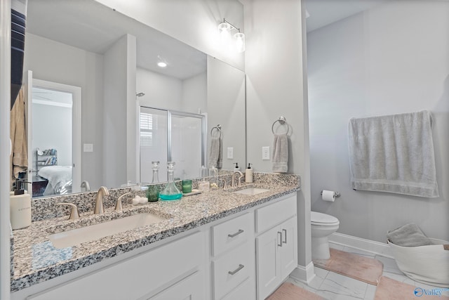 bathroom featuring toilet, vanity, and walk in shower